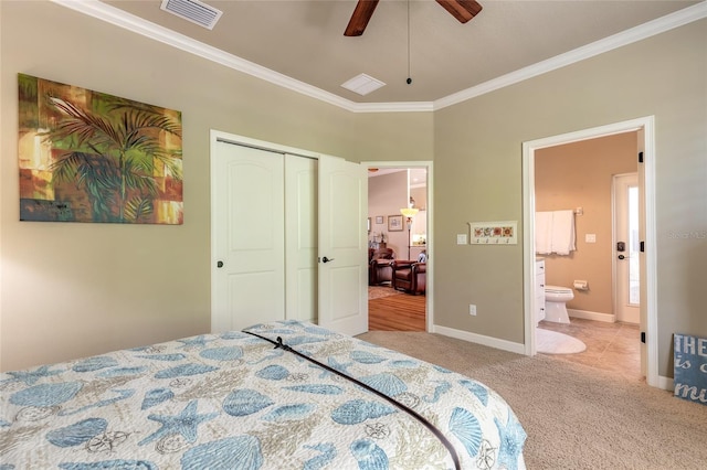 bedroom featuring carpet, a closet, visible vents, baseboards, and ornamental molding