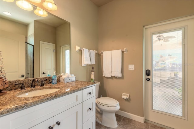 full bath featuring baseboards, toilet, tile patterned floors, vanity, and an enclosed shower