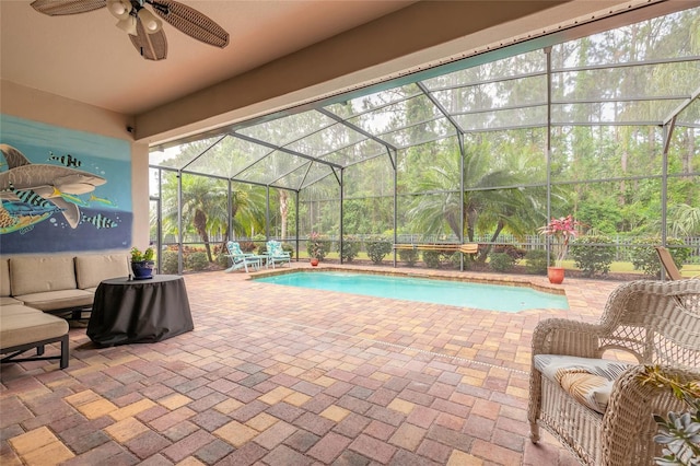 pool with a patio area, a lanai, ceiling fan, and an outdoor living space