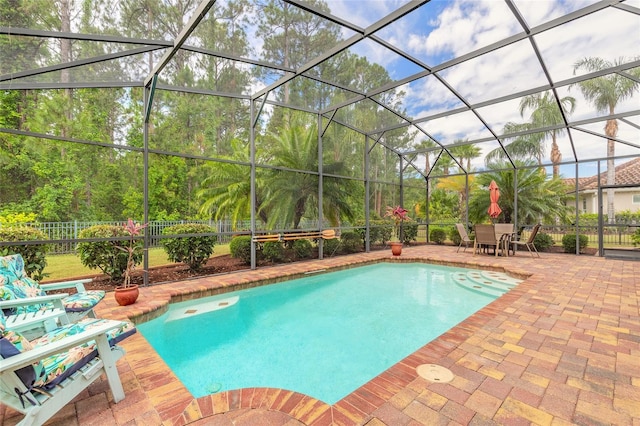 outdoor pool with a patio, fence, and a lanai