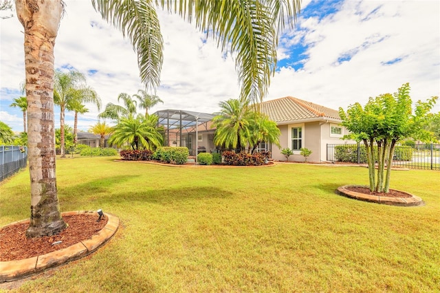 view of yard featuring a lanai and fence