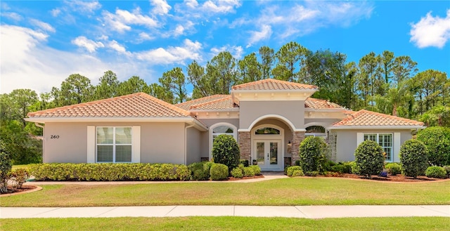 260 Portofino Blvd, New Smyrna Beach, FL 32168 - mediterranean / spanish home featuring stucco siding, a front lawn, french doors, and a tile roof