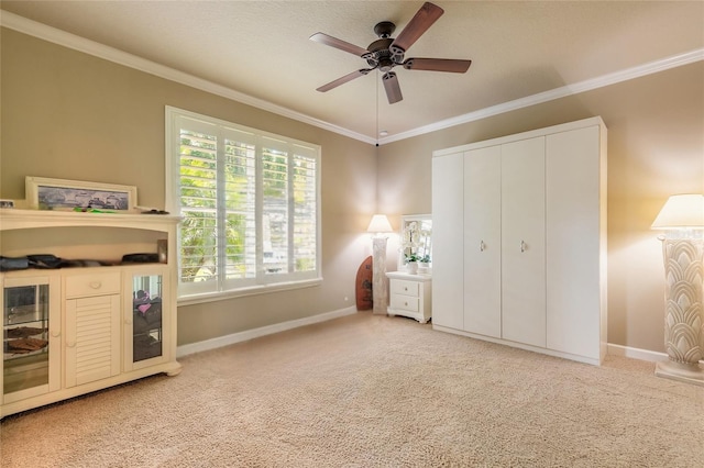 260 Portofino Blvd, New Smyrna Beach, FL 32168 - unfurnished bedroom with crown molding, light colored carpet, baseboards, a ceiling fan, and a closet