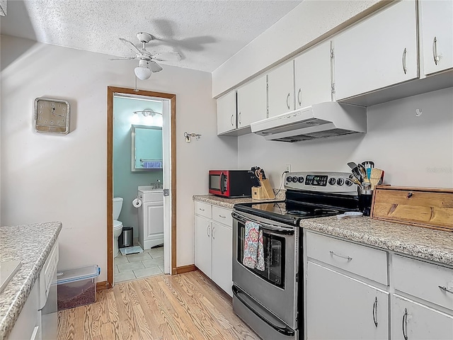 kitchen with ceiling fan, stainless steel range with electric stovetop, light countertops, under cabinet range hood, and light wood-style flooring