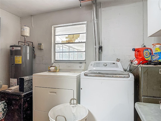 washroom with separate washer and dryer, laundry area, and water heater
