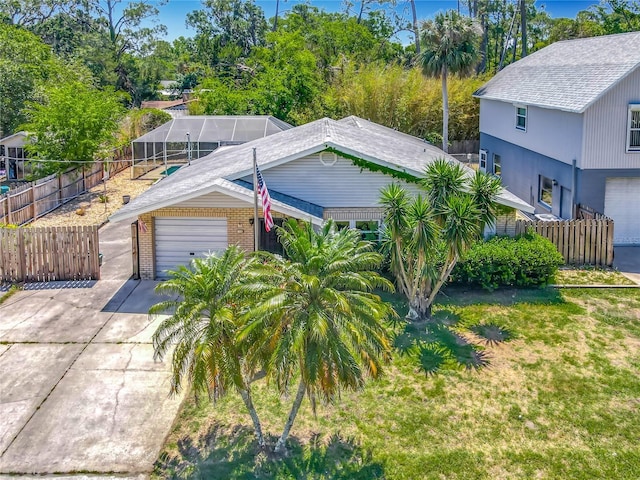 view of front facade featuring concrete driveway, brick siding, fence, and a garage
