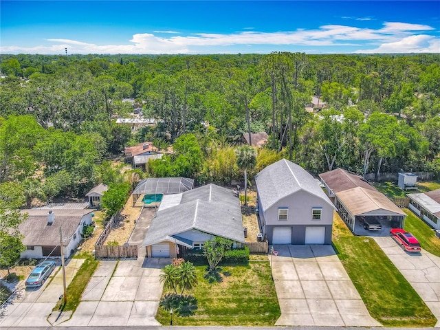 drone / aerial view with a wooded view