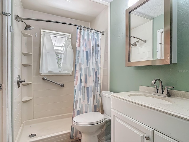 bathroom with vanity, a shower stall, and toilet