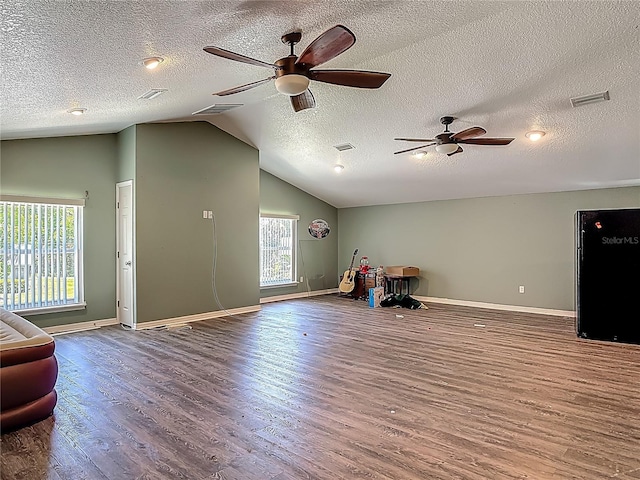 game room with visible vents, wood finished floors, baseboards, ceiling fan, and vaulted ceiling