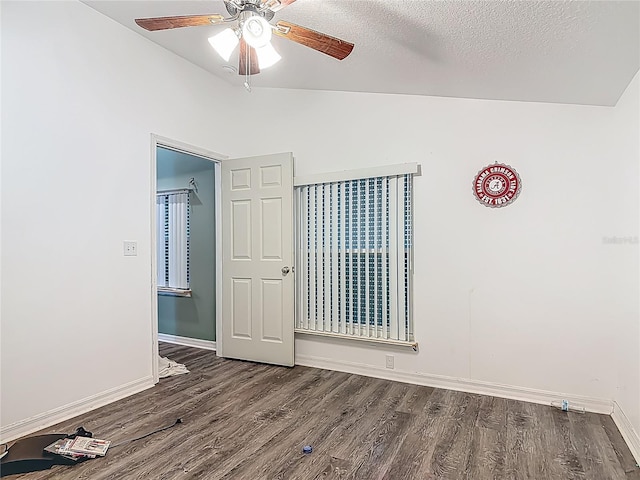 unfurnished bedroom with ceiling fan, baseboards, vaulted ceiling, and wood finished floors