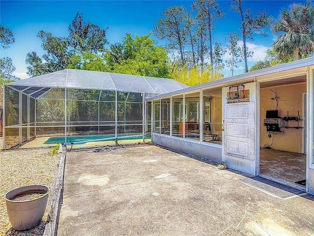 view of patio with a lanai and an outdoor pool