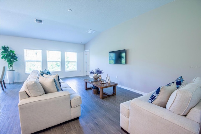 living area with baseboards, visible vents, wood finished floors, and lofted ceiling