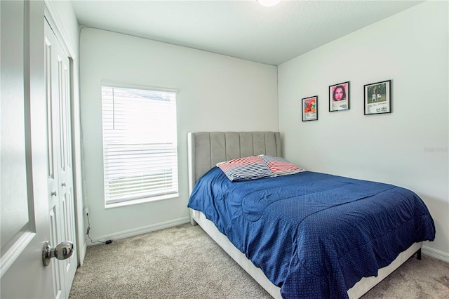 carpeted bedroom with baseboards and multiple windows
