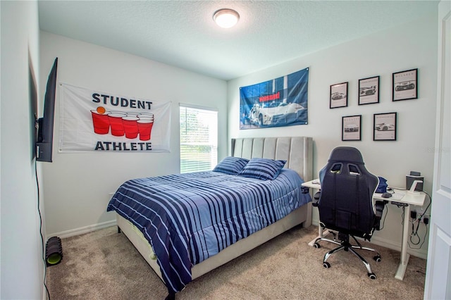 bedroom with carpet flooring, a textured ceiling, and baseboards