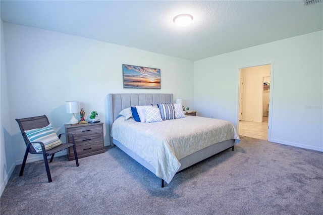 carpeted bedroom with baseboards and a textured ceiling