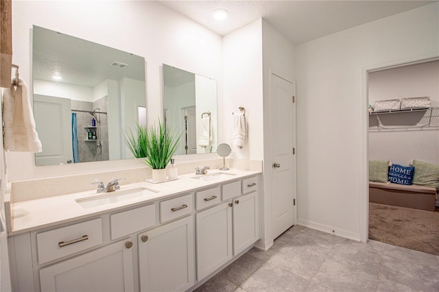 full bathroom with visible vents, a sink, and a closet