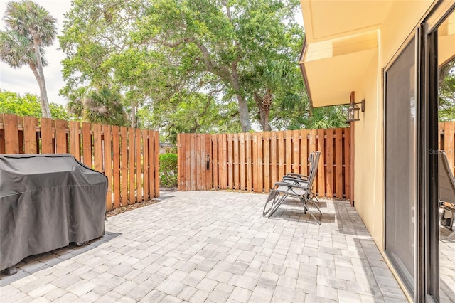 view of patio featuring fence and area for grilling