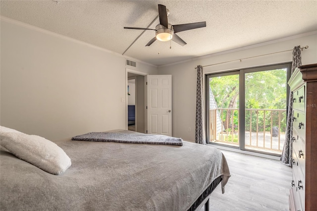 bedroom with light wood-style flooring, a textured ceiling, ornamental molding, ceiling fan, and access to exterior