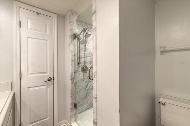 bathroom featuring a shower stall and toilet