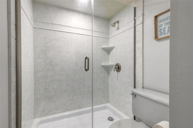 full bath featuring a shower stall and toilet