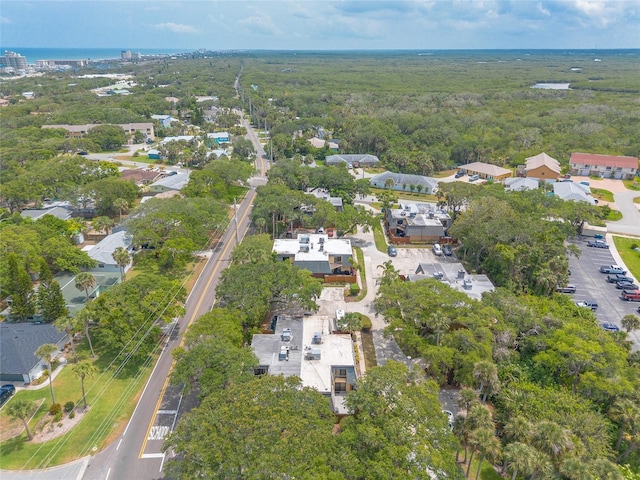 aerial overview of property's location with a heavily wooded area and nearby suburban area
