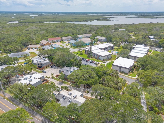 view of property location with a large body of water and a forest