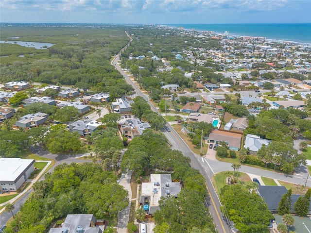 aerial view of property and surrounding area featuring a large body of water and nearby suburban area