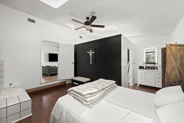 bedroom with a ceiling fan, dark wood-type flooring, lofted ceiling, and visible vents