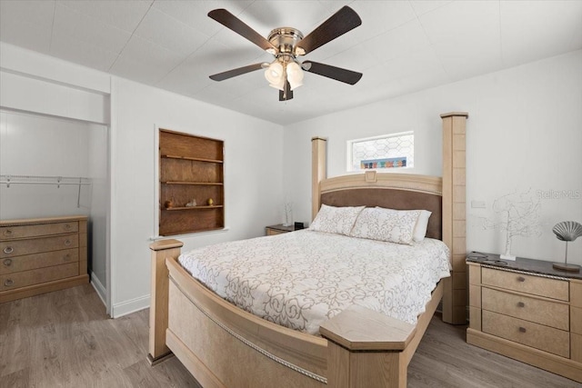 bedroom featuring light wood-style floors and ceiling fan