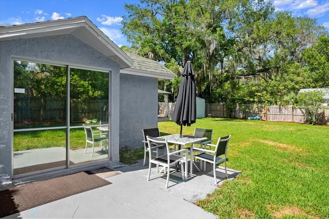 exterior space with a fenced backyard and outdoor dining space