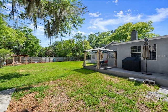 view of yard featuring a fenced backyard, a patio, and a gazebo