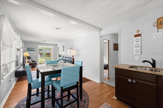 dining room with light wood-style flooring