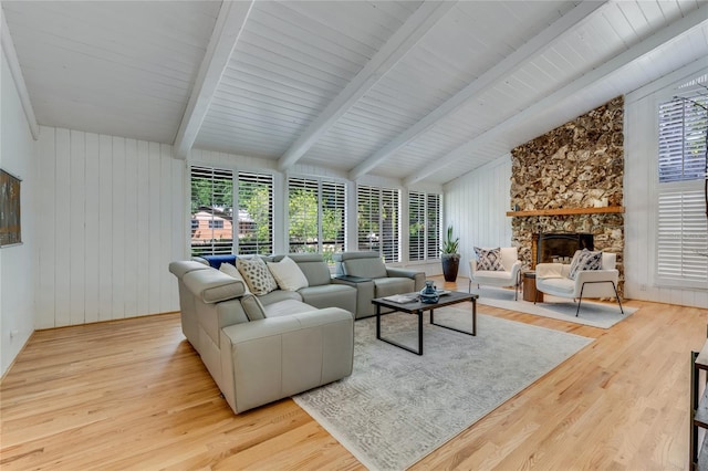 living room with a fireplace, lofted ceiling with beams, and wood finished floors