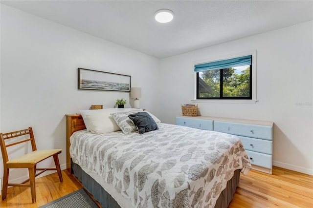 bedroom featuring baseboards and light wood-style floors