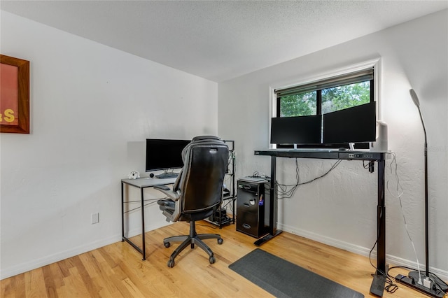 office featuring baseboards and wood finished floors