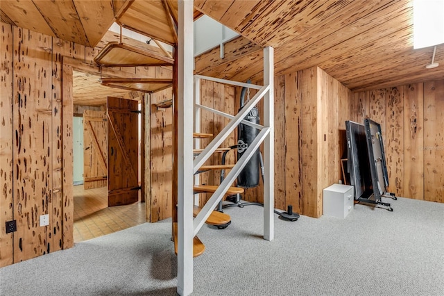 interior space with carpet, wooden ceiling, and wooden walls