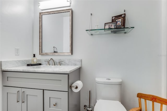 half bathroom featuring toilet and vanity
