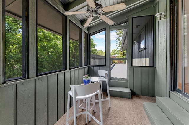 sunroom featuring ceiling fan