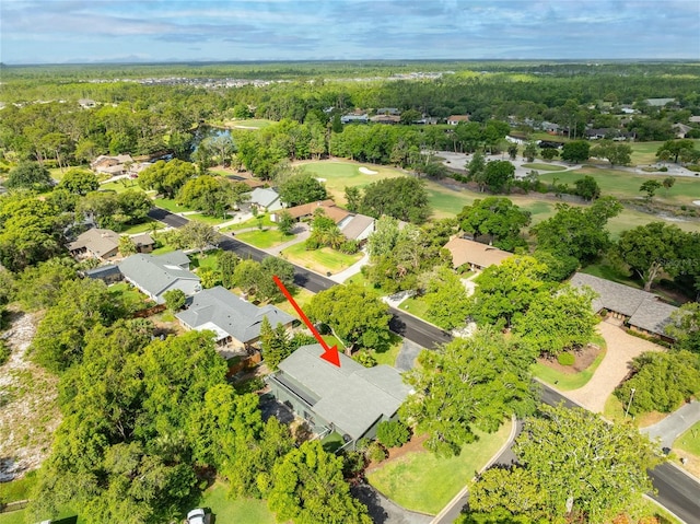 birds eye view of property with view of golf course and a residential view