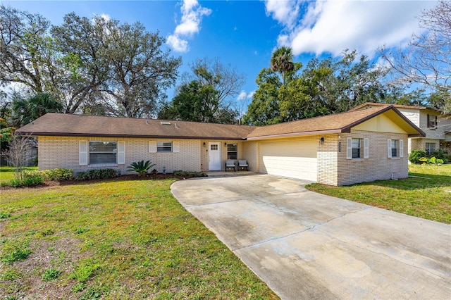 single story home featuring concrete driveway, a front lawn, brick siding, and an attached garage