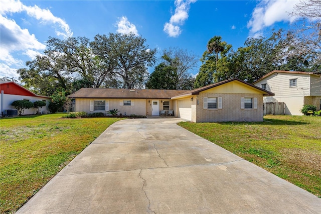 ranch-style house with concrete driveway, a front lawn, brick siding, and an attached garage