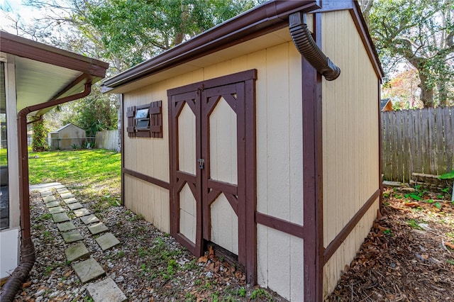 view of shed with fence