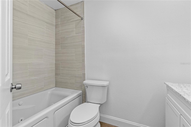 bathroom with vanity, toilet, baseboards, and  shower combination