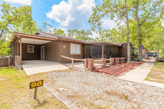 view of front of home with an attached carport and board and batten siding