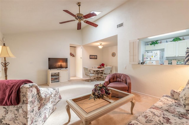 living room with light colored carpet, a ceiling fan, high vaulted ceiling, and baseboards