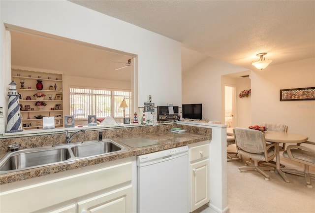 kitchen with dishwasher, a sink, light carpet, a textured ceiling, and white cabinets