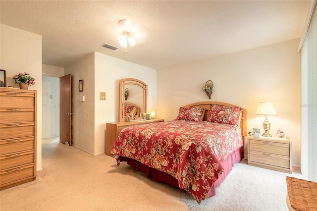 bedroom with light carpet and baseboards