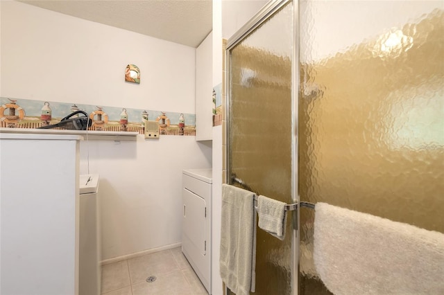 laundry room with washing machine and clothes dryer and light tile patterned floors