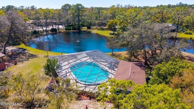 aerial view of property and surrounding area featuring a large body of water and a forest