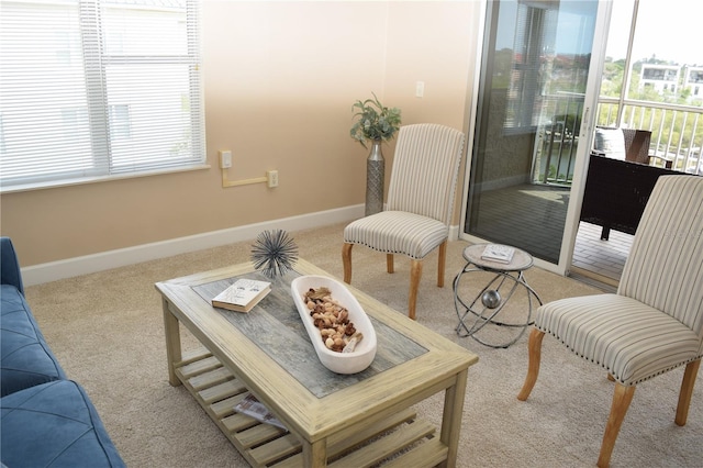 living room with plenty of natural light, baseboards, and carpet floors